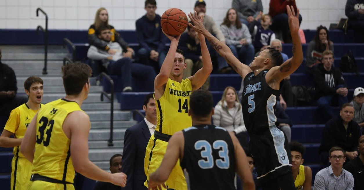 Lattimer's 9 threes pace Wolverines in opening win